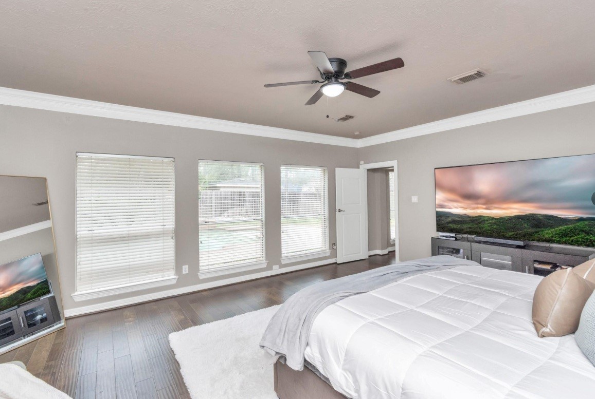 16522 Champions Cove Circle Spring, TX 77379 - Photo 19 of 30 a bedroom with a bed and a flat screen tv