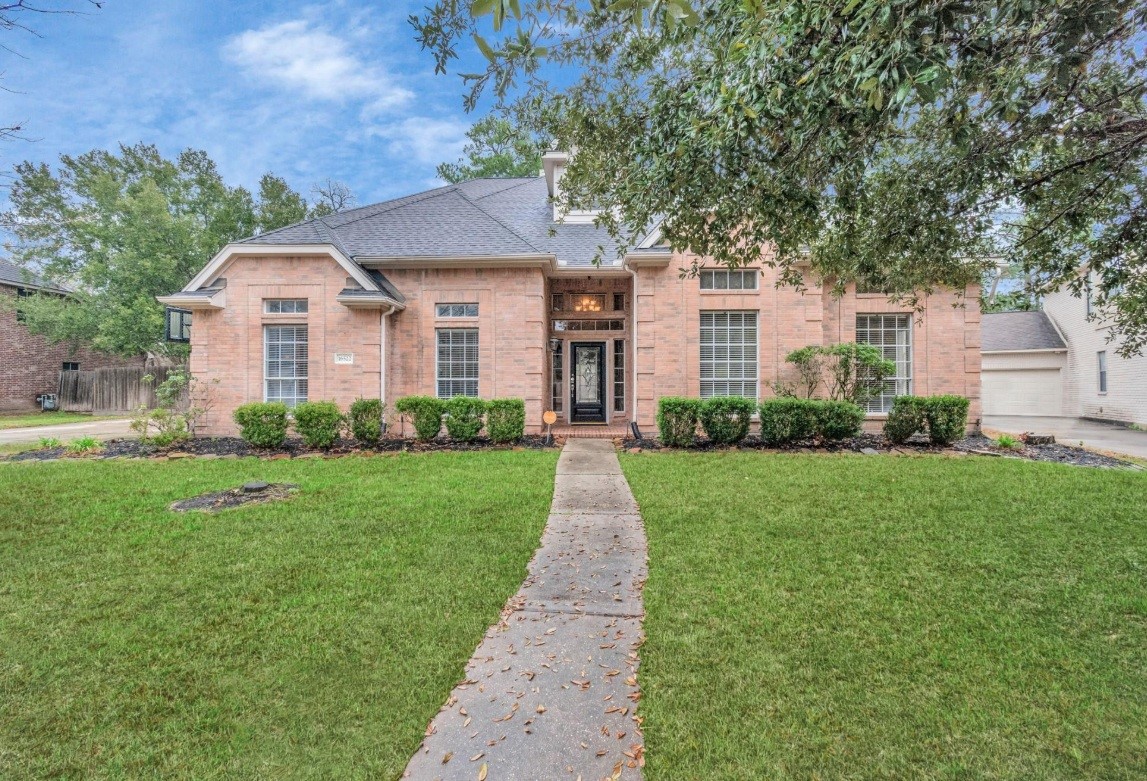 16522 Champions Cove Circle Spring, TX 77379 - Photo 2 of 30 a front view of a house with a yard and trees