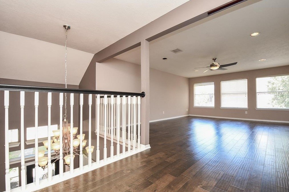 16522 Champions Cove Circle Spring, TX 77379 - Photo 24 of 30 a view of wooden floor and windows in a room