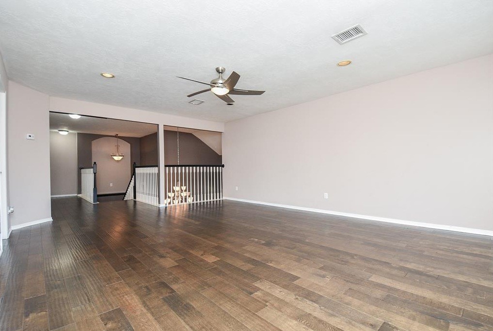 16522 Champions Cove Circle Spring, TX 77379 - Photo 25 of 30 a view of empty room with wooden floor and ceiling fan