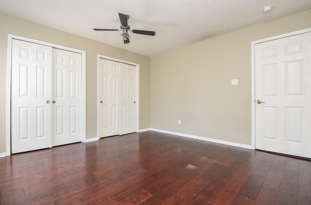 16522 Champions Cove Circle Spring, TX 77379 - Photo 26 of 30 an empty room with wooden floor and windows
