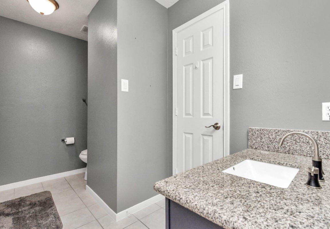 16522 Champions Cove Circle Spring, TX 77379 - Photo 28 of 30 a bathroom with a granite countertop sink and a mirror