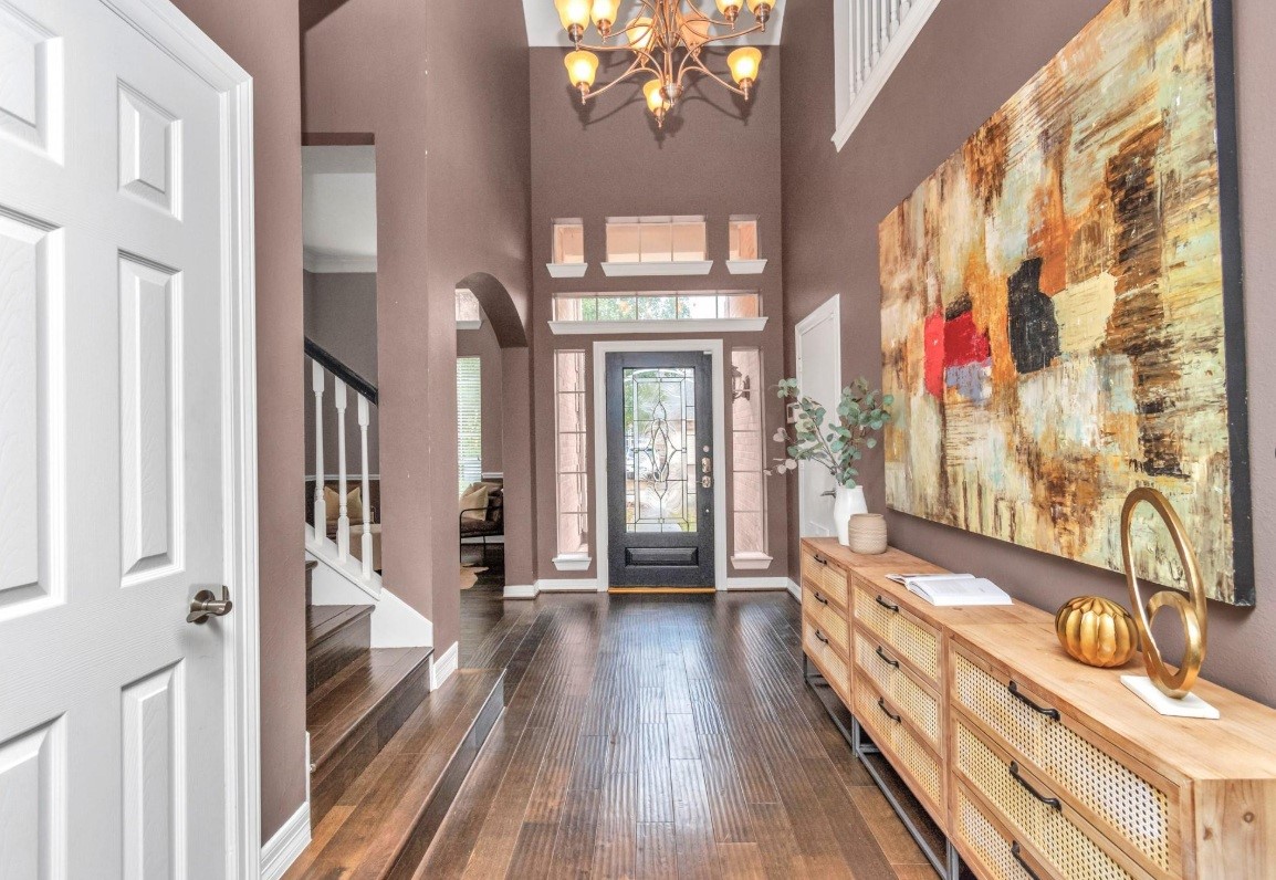 16522 Champions Cove Circle Spring, TX 77379 - Photo 5 of 30 a view of a hallway with wooden floor and staircase