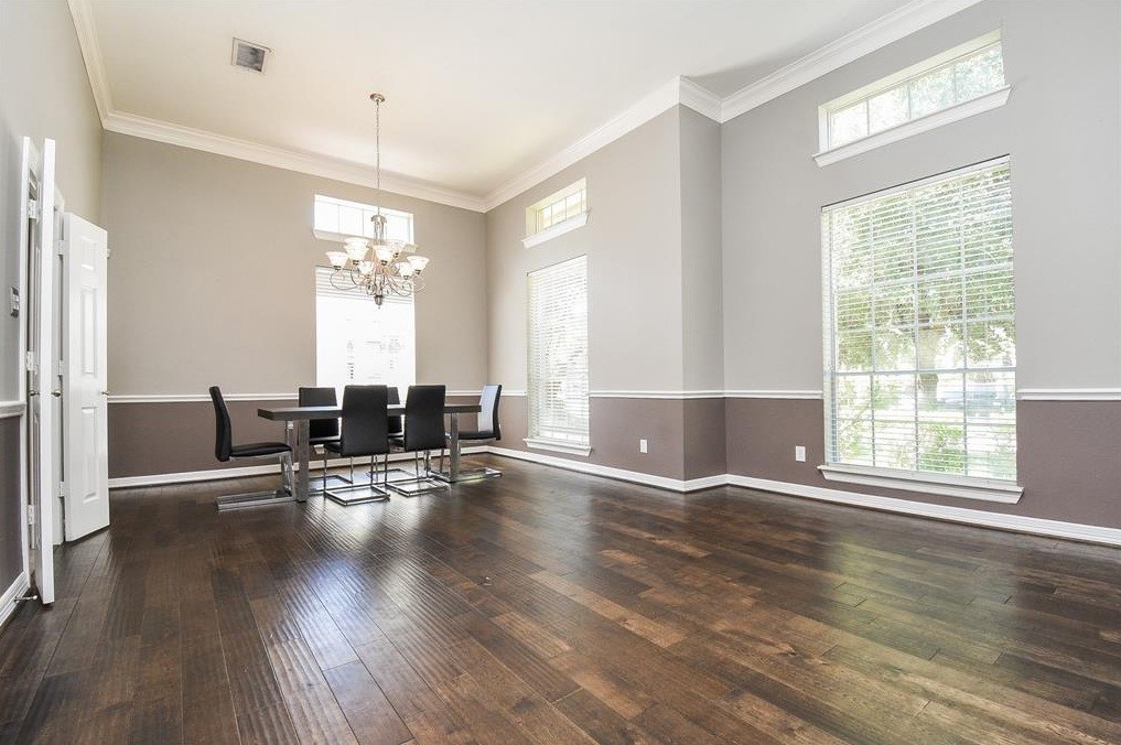 16522 Champions Cove Circle Spring, TX 77379 - Photo 6 of 30 an empty room with wooden floor and windows