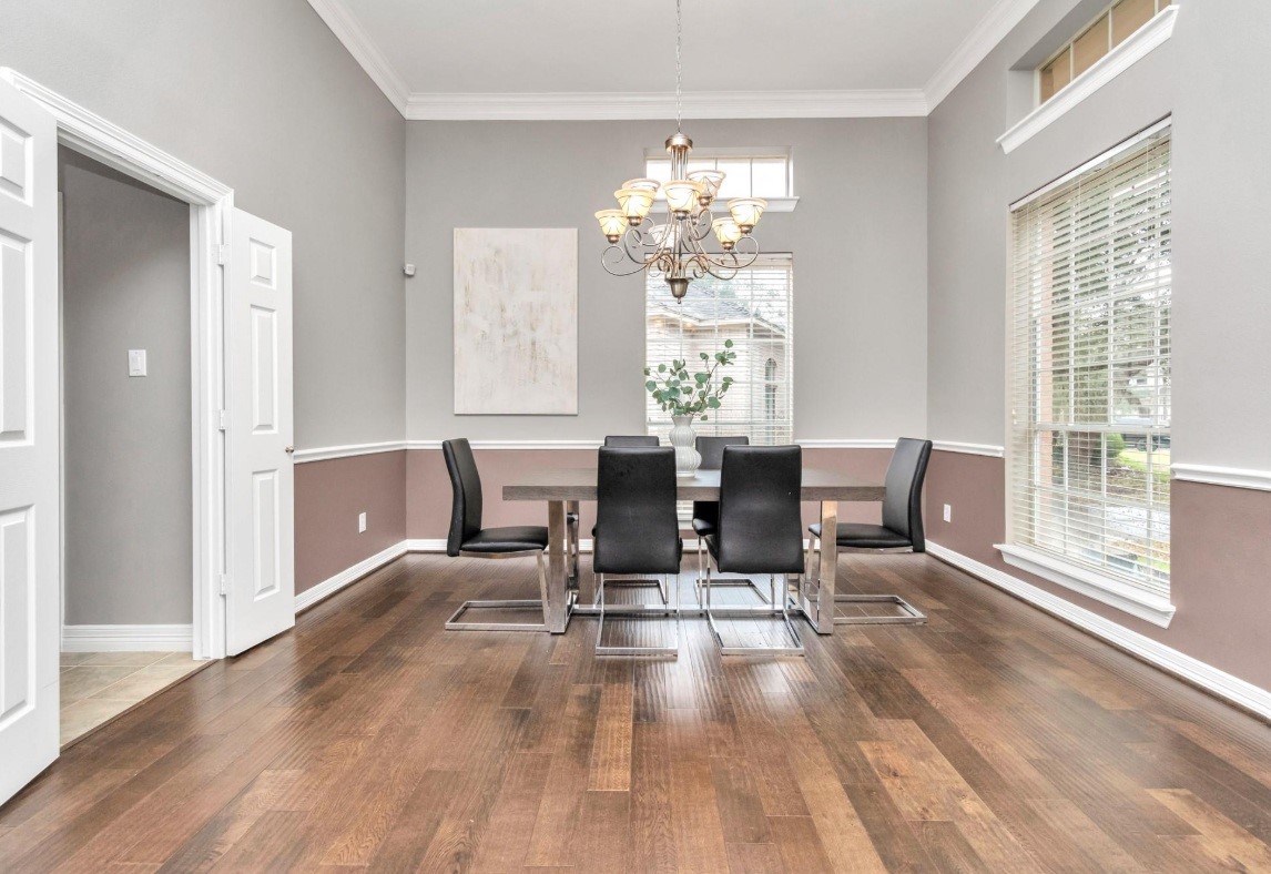 16522 Champions Cove Circle Spring, TX 77379 - Photo 8 of 30 a dining room with furniture a chandelier and wooden floor