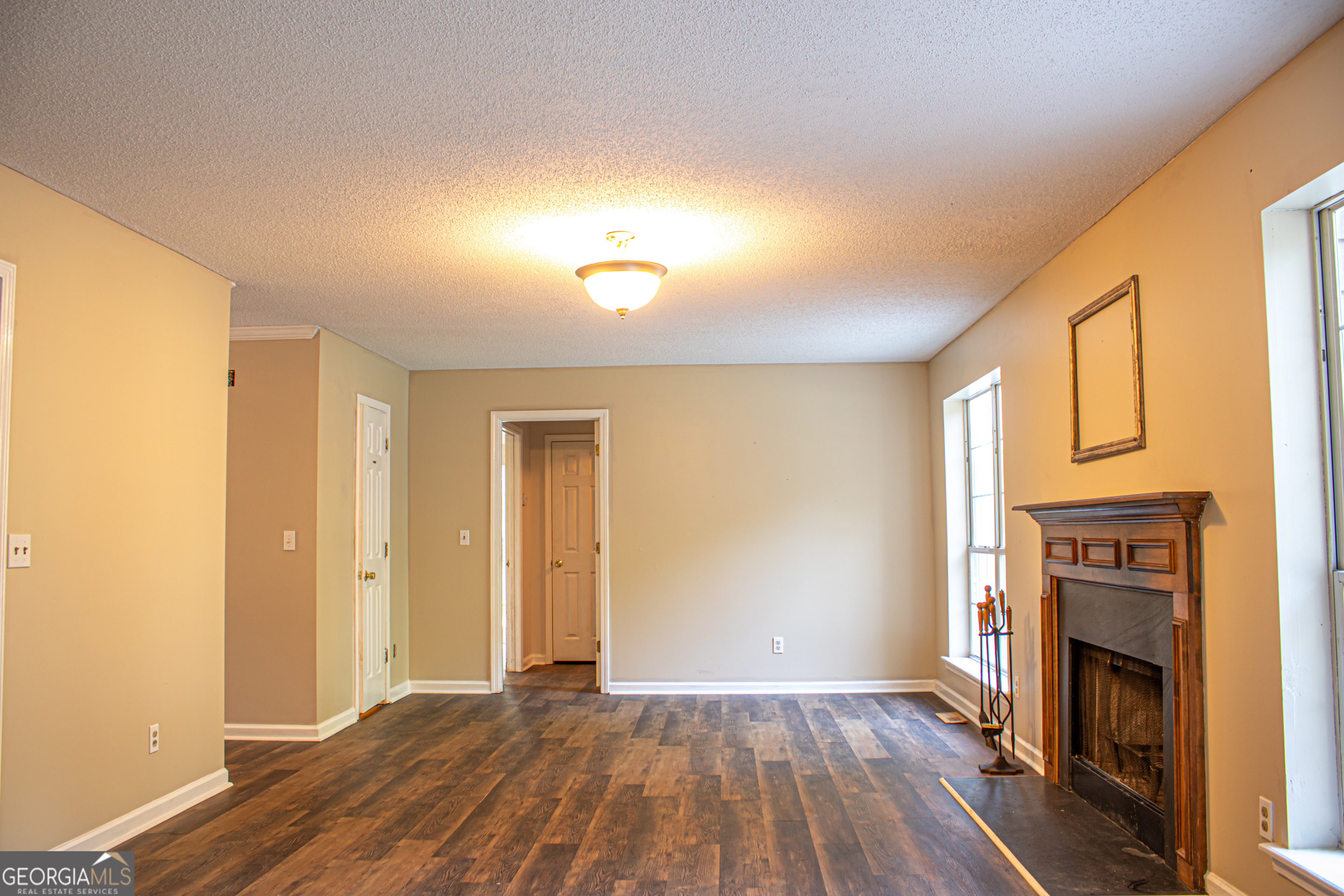 240 Harkness Road Jackson, GA 30233 - Photo 14 of 54 a view of empty room with wooden floor and fireplace