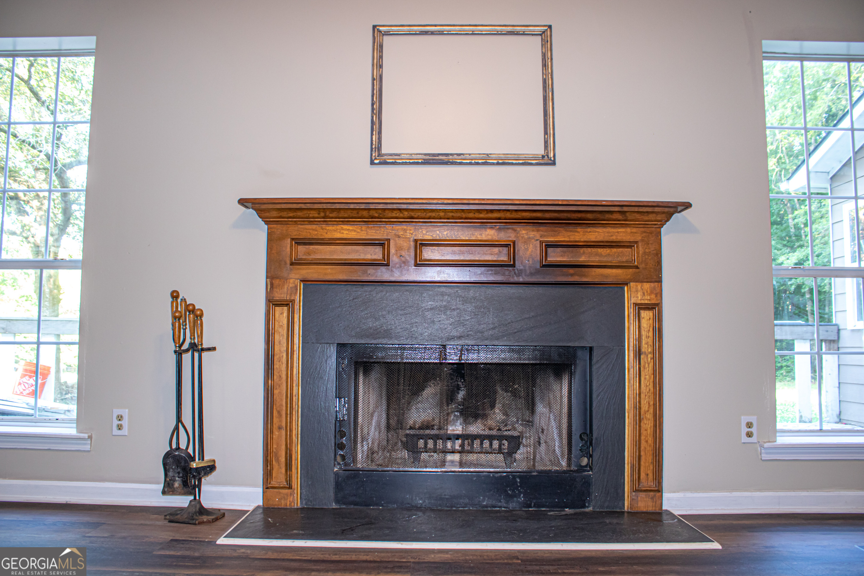 240 Harkness Road Jackson, GA 30233 - Photo 15 of 54 a living room with a fireplace and windows