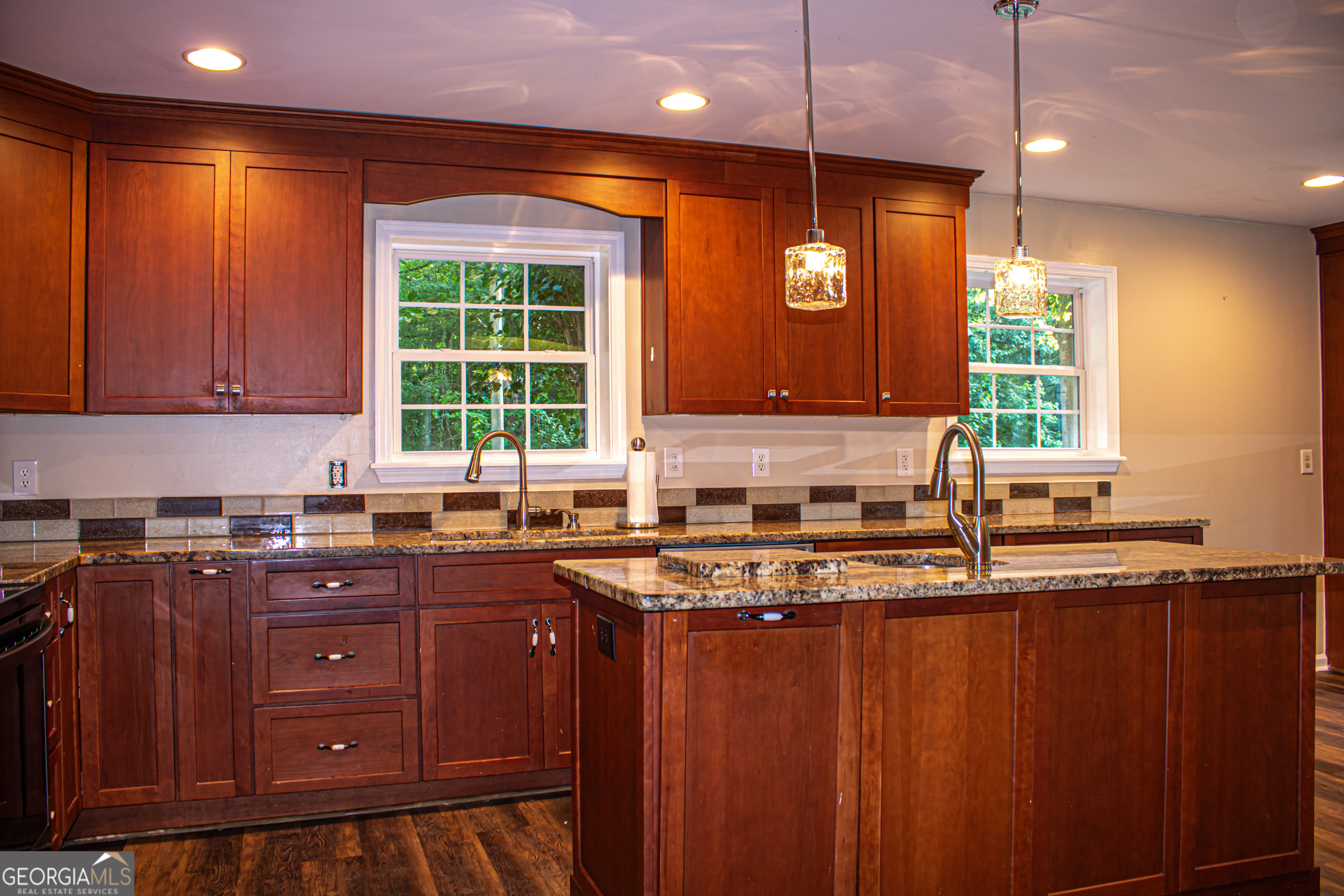 240 Harkness Road Jackson, GA 30233 - Photo 18 of 54 a kitchen with stainless steel appliances granite countertop wooden cabinets and a window