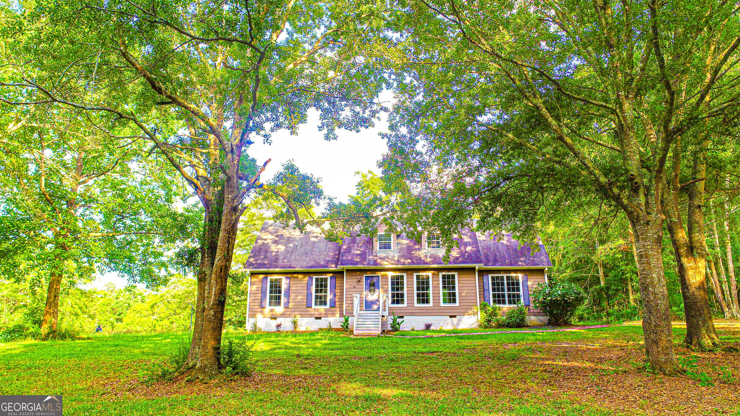 240 Harkness Road Jackson, GA 30233 - Photo 2 of 54 a front view of a house with a garden