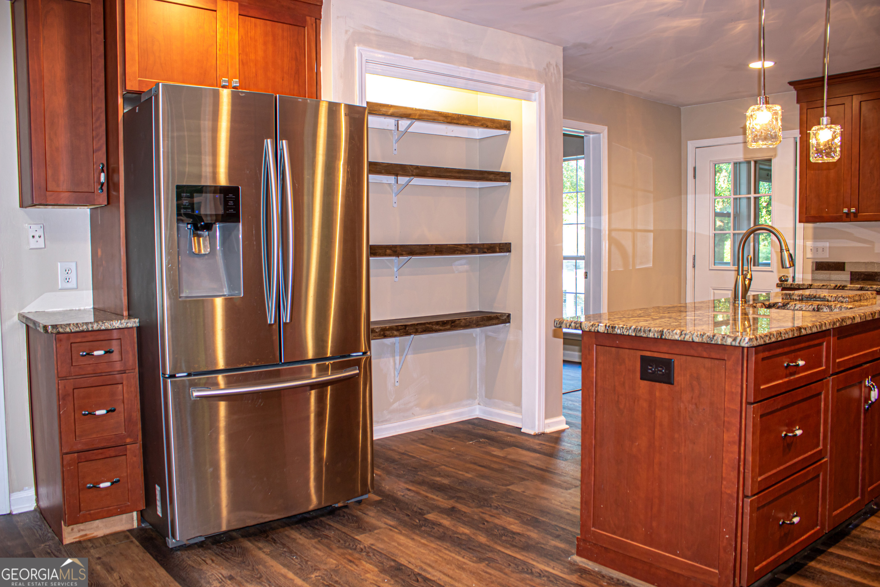 240 Harkness Road Jackson, GA 30233 - Photo 26 of 54 a kitchen with stainless steel appliances granite countertop a refrigerator and a wooden floor