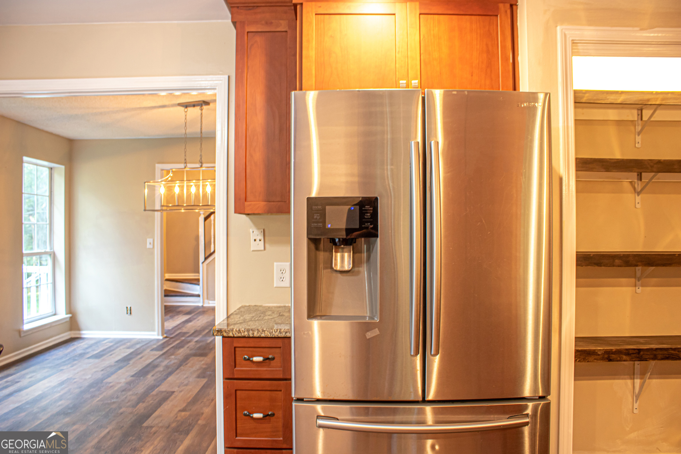 240 Harkness Road Jackson, GA 30233 - Photo 28 of 54 a view of a kitchen with wooden floor and refrigerator