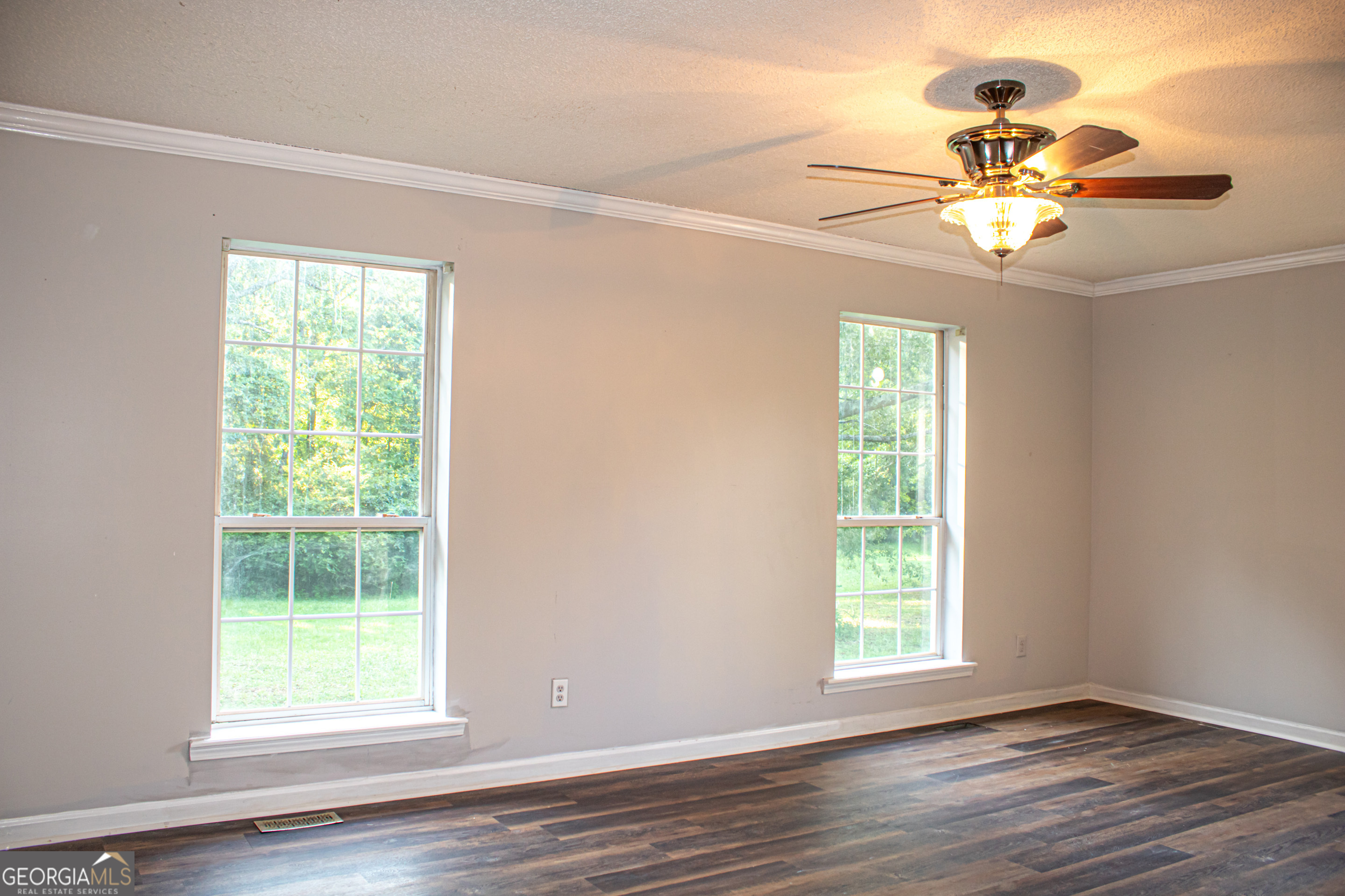 240 Harkness Road Jackson, GA 30233 - Photo 33 of 54 a view of an empty room with wooden floor and a window