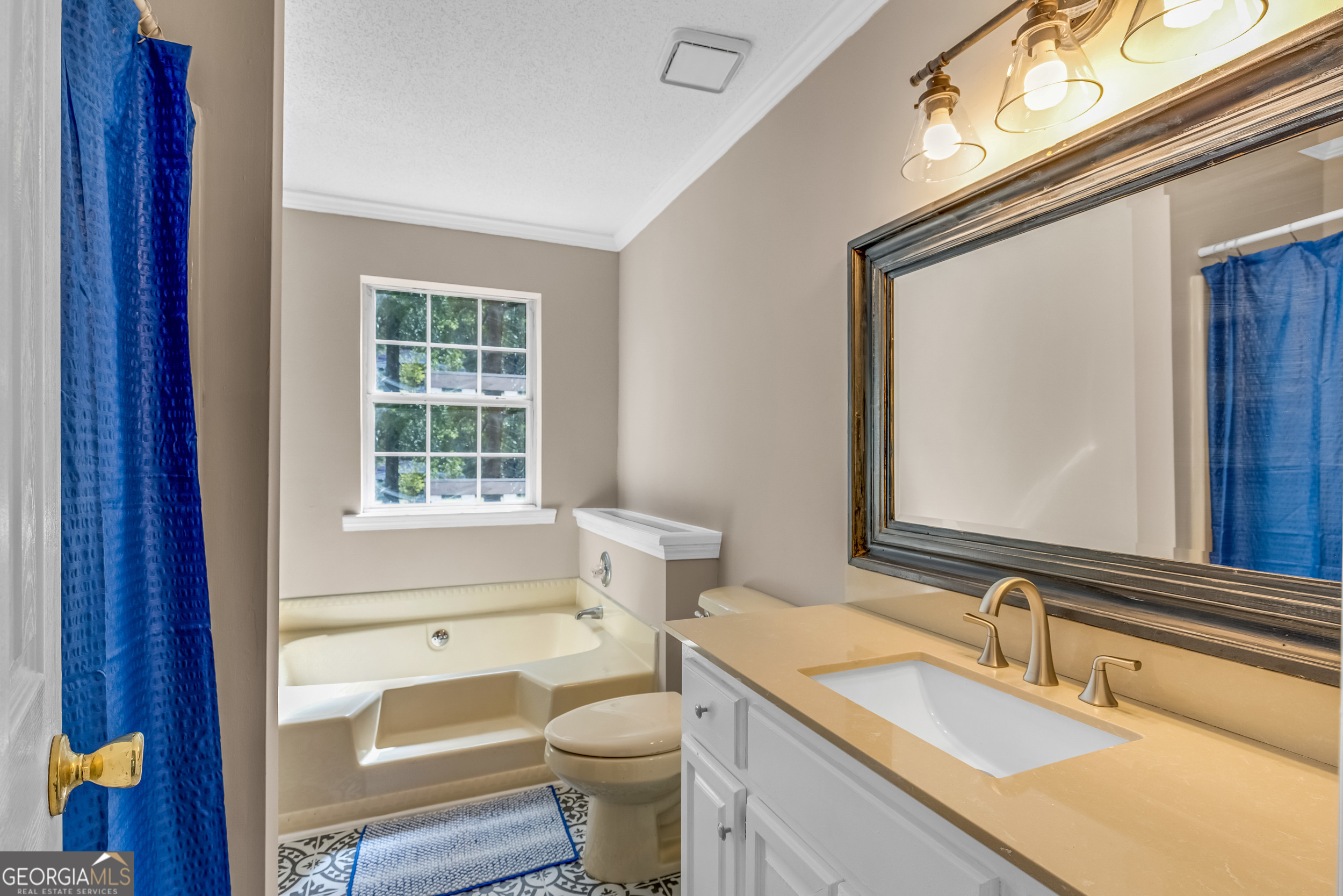 240 Harkness Road Jackson, GA 30233 - Photo 34 of 54 a bathroom with a granite countertop toilet a sink and a mirror