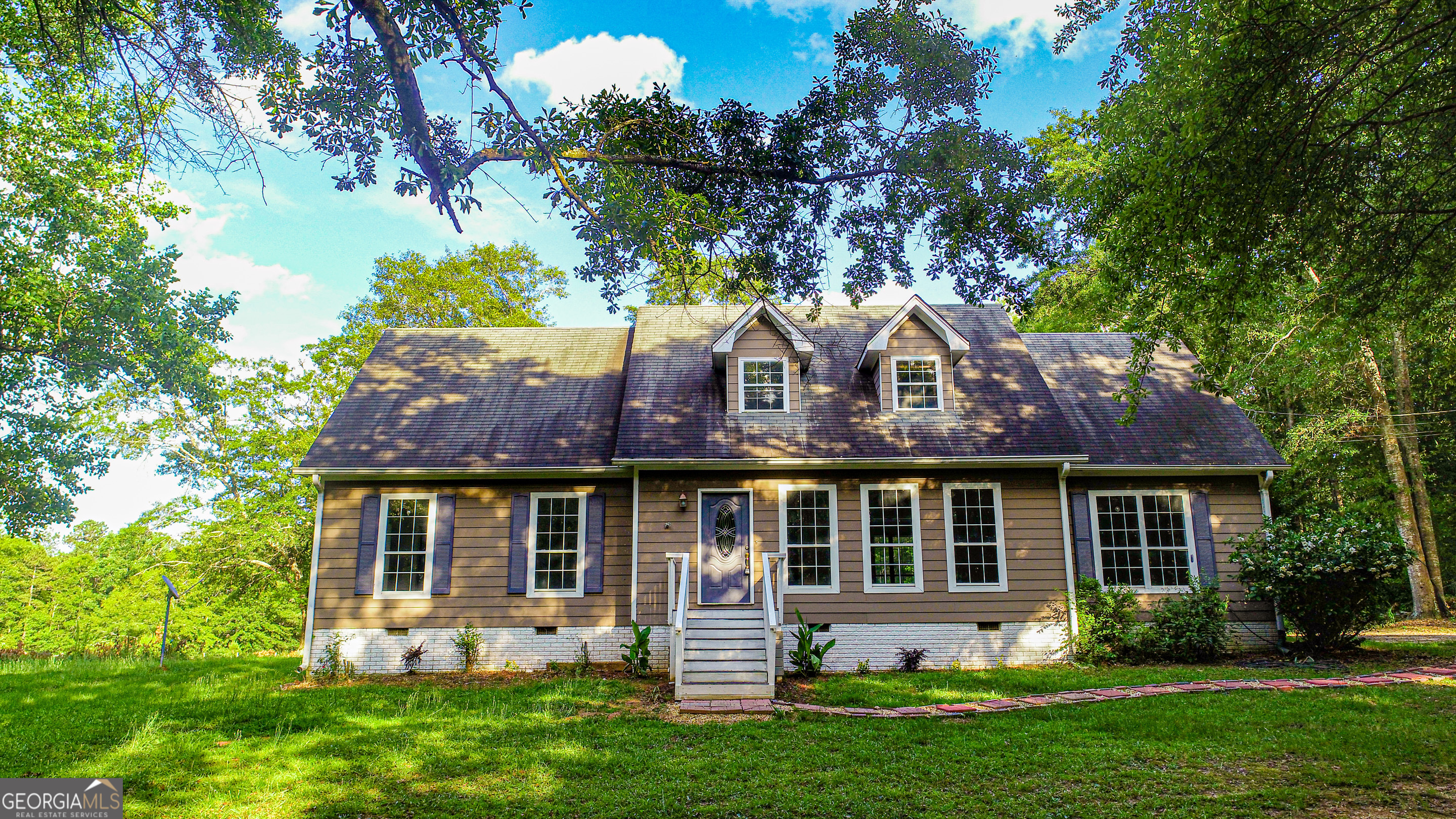 240 Harkness Road Jackson, GA 30233 - Photo 7 of 54 a front view of a house with a yard