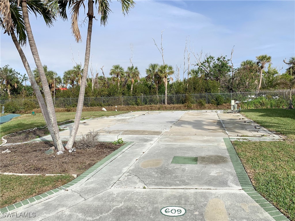 19681 Summerlin Road, Unit 609T Fort Myers, FL 33908 - Photo 2 of 20 a backyard of a house with lots of green space