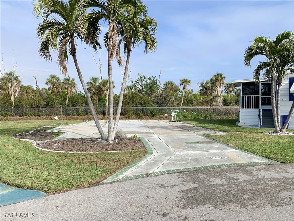 19681 Summerlin Road, Unit 609T Fort Myers, FL 33908 - Photo 3 of 20 a palm tree sitting in front of a house with a yard