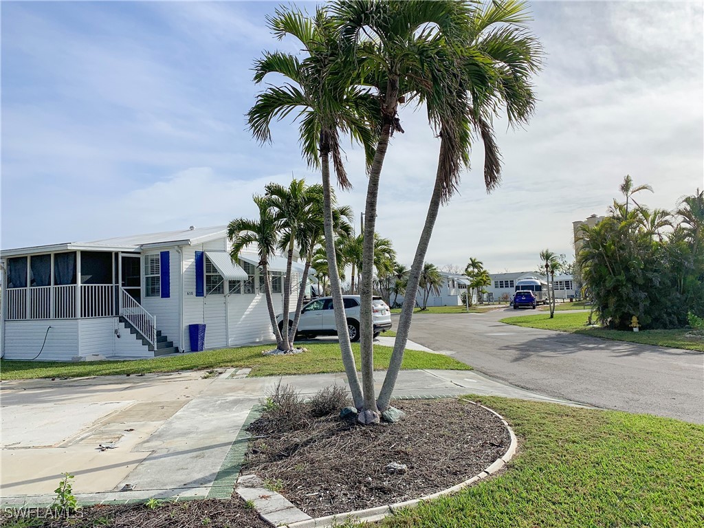 19681 Summerlin Road, Unit 609T Fort Myers, FL 33908 - Photo 4 of 20 a front view of a house with garden