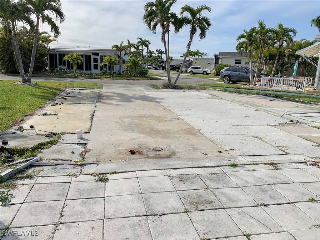 19681 Summerlin Road, Unit 609T Fort Myers, FL 33908 - Photo 7 of 20 a view of a yard with cars