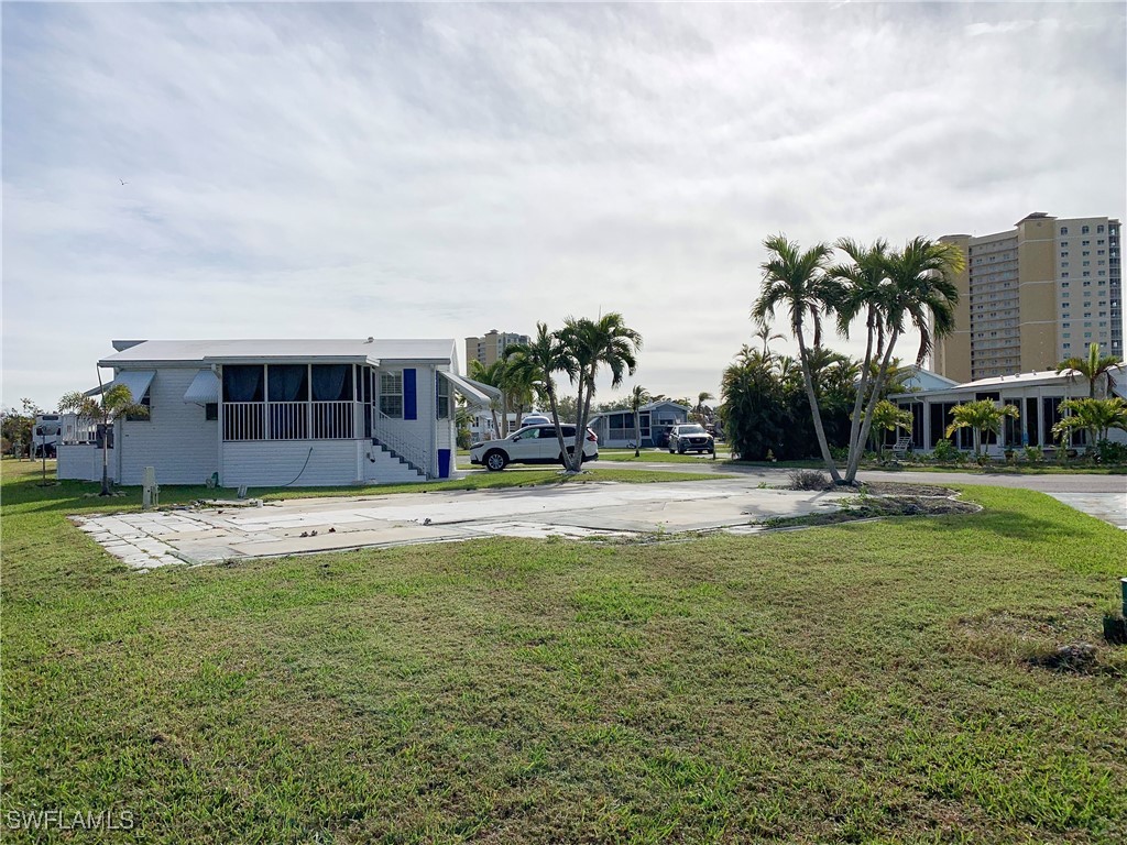 19681 Summerlin Road, Unit 609T Fort Myers, FL 33908 - Photo 10 of 20 a view of swimming pool with outdoor seating and house in the background