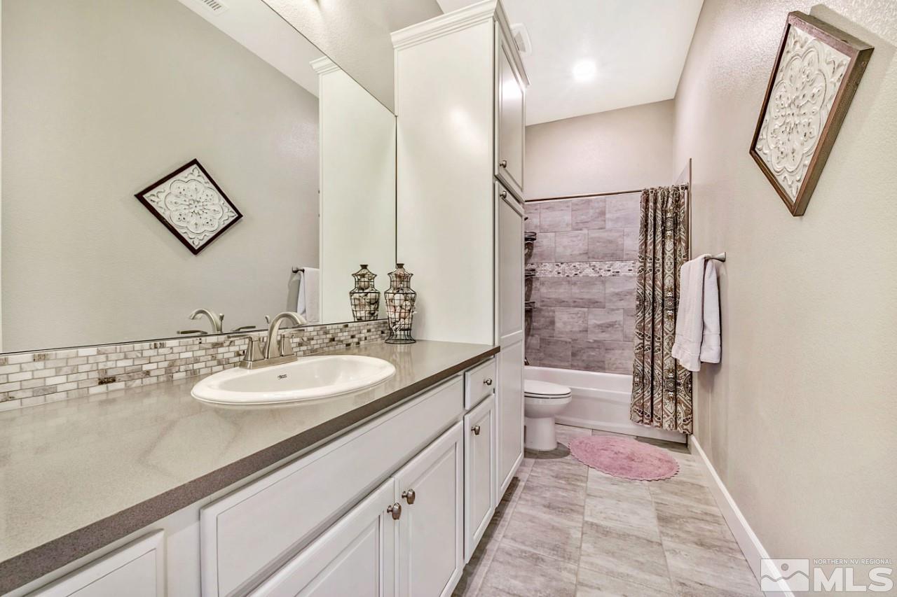 2010 Back Nine Trail Reno, NV 89523 - Photo 17 of 25 a spacious bathroom with a granite countertop sink a toilet and a mirror