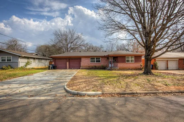 a view of a house with a yard covered in snow