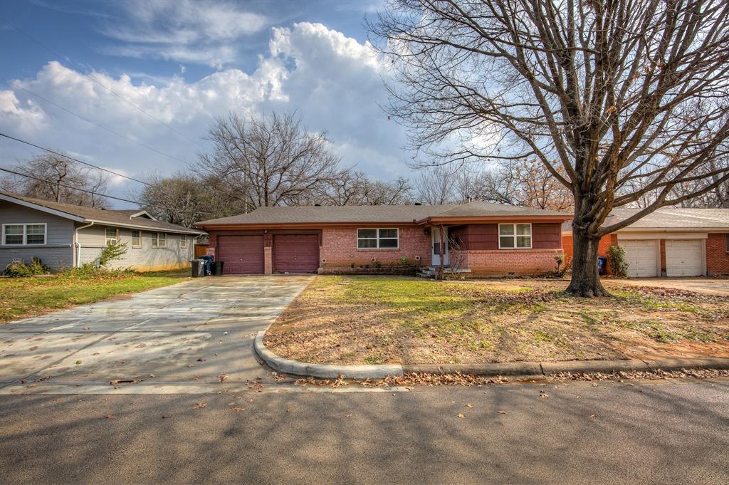 a view of a house with a yard covered in snow