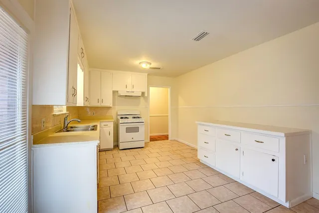 a kitchen with stainless steel appliances a stove a sink and a refrigerator