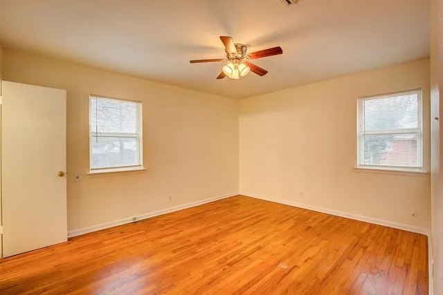 a view of a room with wooden floor and a window