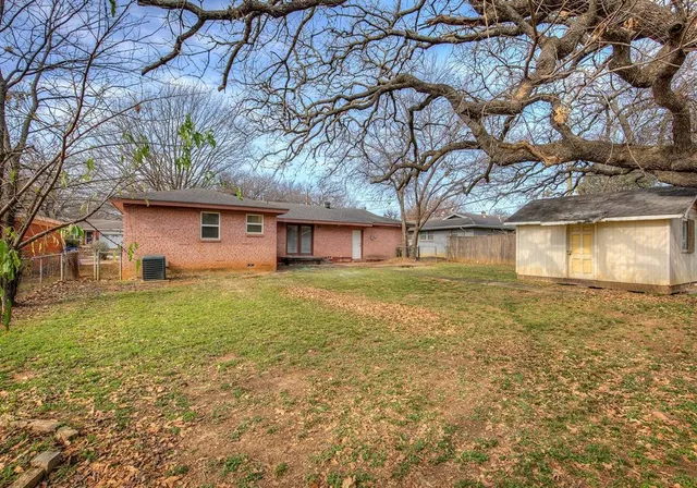 a front view of house with yard and trees