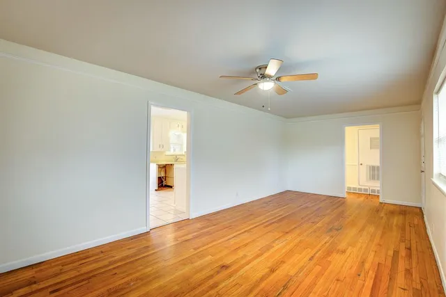 a bedroom with a bed and a chandelier fan