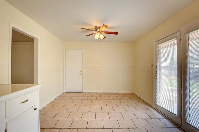 a view of a room with window and ceiling fan