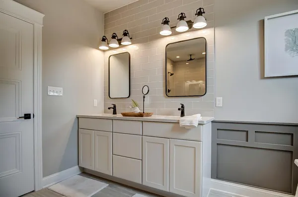 a bathroom with a toilet a sink a mirror and vanity