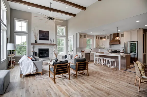 a living room with furniture a piano and a flat screen tv
