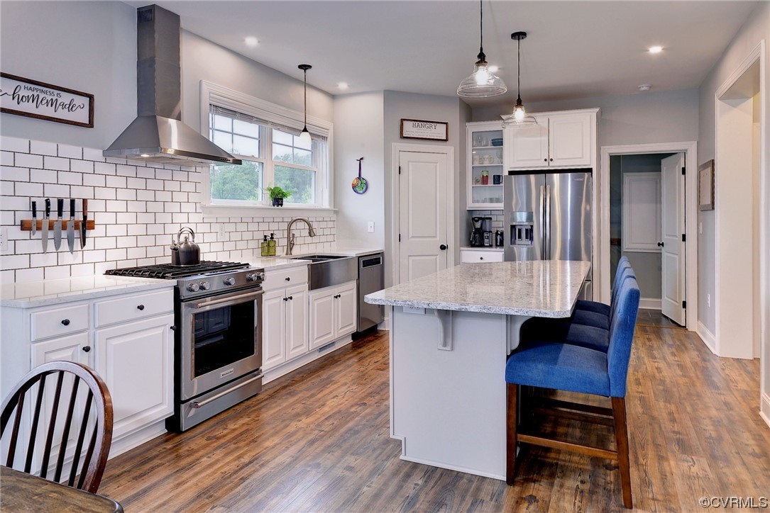 2970 Evergreen Road Providence Forge, VA 23140 - Photo 19 of 48 a kitchen with stainless steel appliances kitchen island granite countertop a stove a sink dishwasher a refrigerator and a dining table with wooden floor