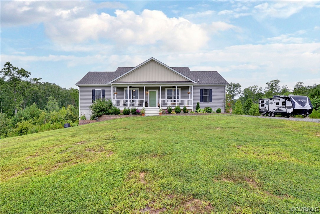 2970 Evergreen Road Providence Forge, VA 23140 - Photo 6 of 48 a front view of a house with a garden and trees