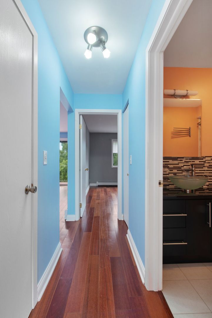 493 McHenry Road, Unit 3B Wheeling, IL 60090 - Photo 11 of 18 a view of a hallway view with wooden floor and staircase