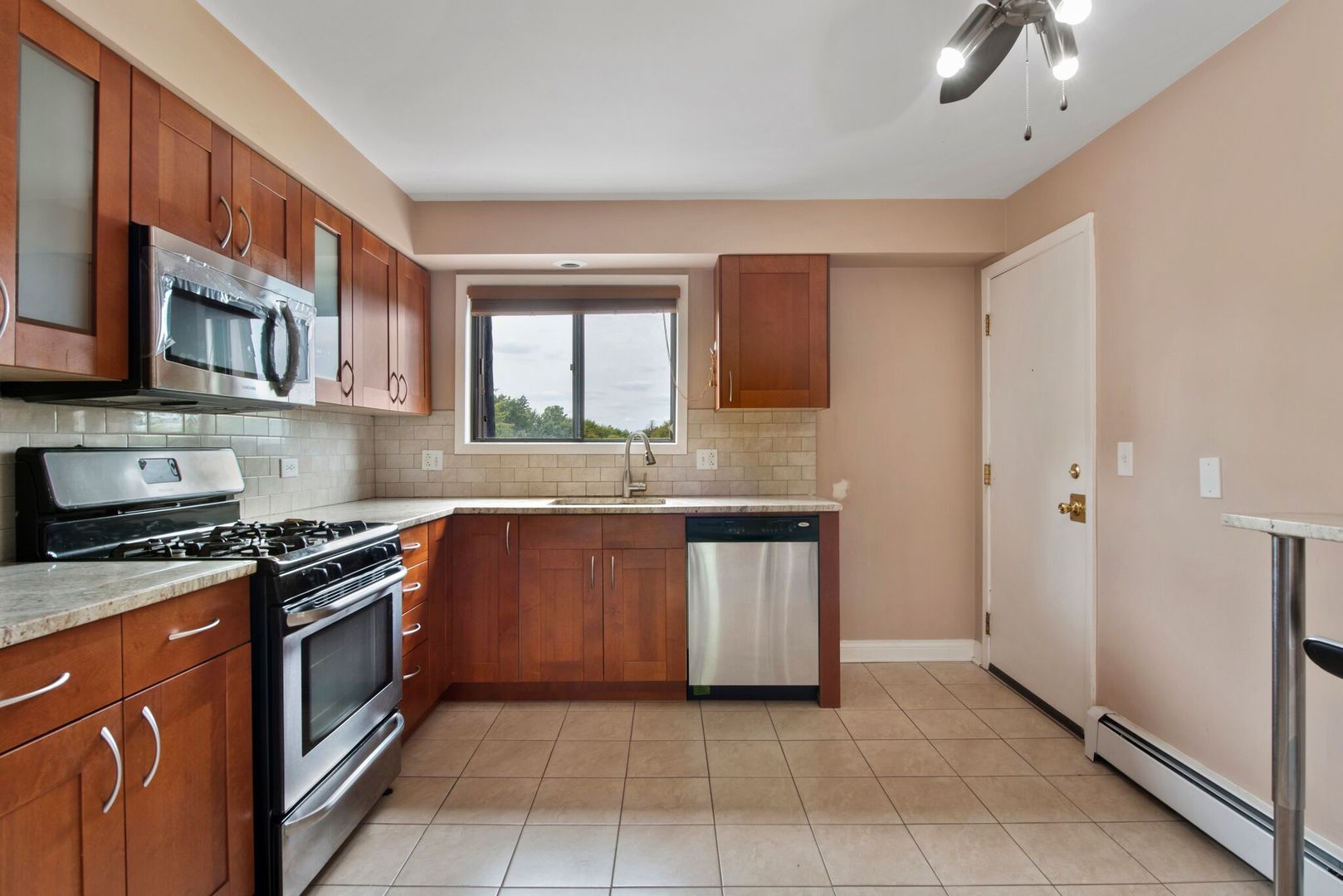 493 McHenry Road, Unit 3B Wheeling, IL 60090 - Photo 4 of 18 a kitchen with stainless steel appliances granite countertop a stove and a sink