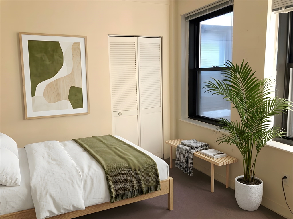475 Commonwealth Avenue, Unit 304 Boston, MA 02215 - Photo 4 of 8 a bedroom with a bed and a potted plant