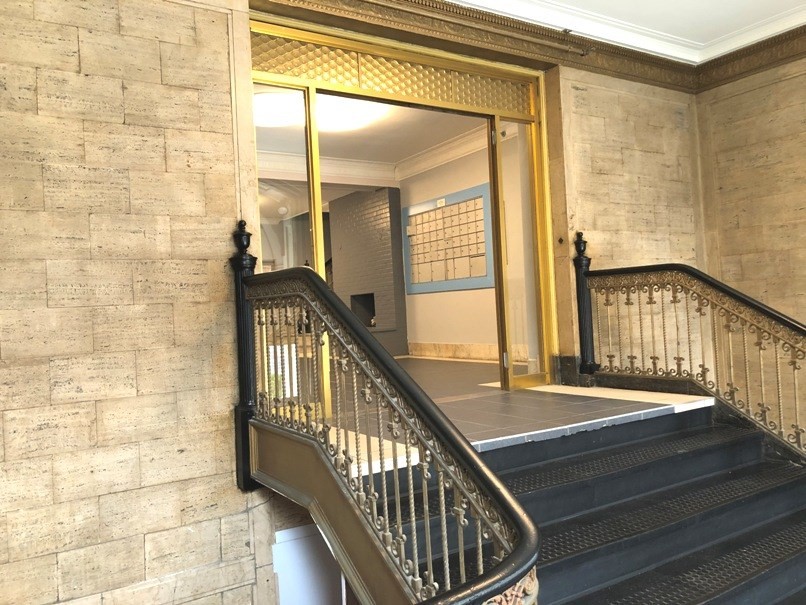 475 Commonwealth Avenue, Unit 304 Boston, MA 02215 - Photo 5 of 8 a view of staircase with railing and a chandelier