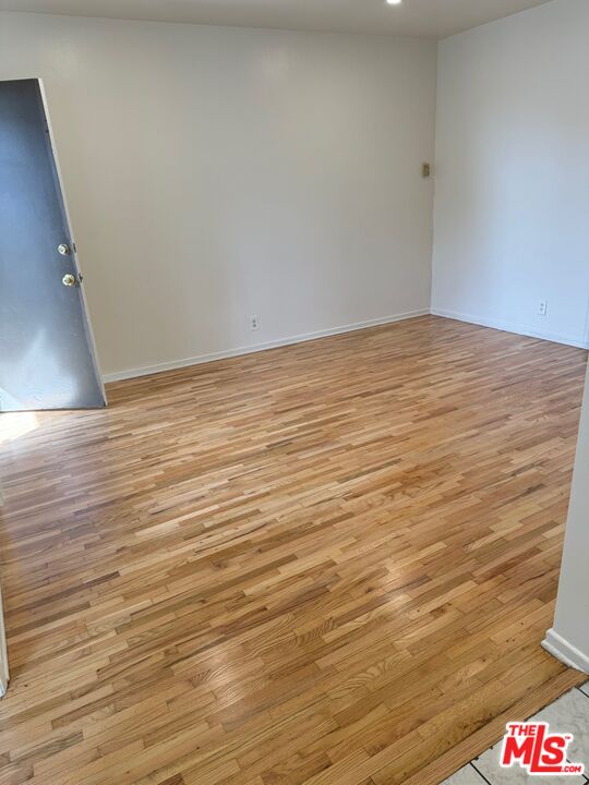 1336 Berkeley Street, Unit 2 Santa Monica, CA 90404 - Photo 6 of 8 a view of an empty room with wooden floor