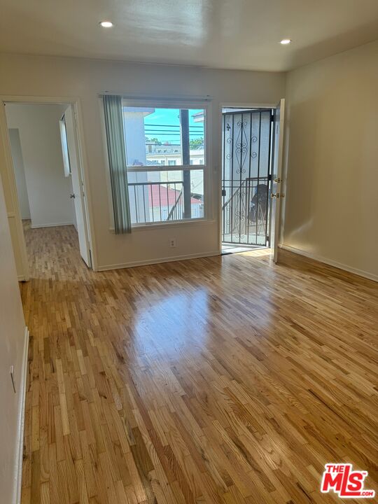 1336 Berkeley Street, Unit 2 Santa Monica, CA 90404 - Photo 7 of 8 wooden floor in an empty room with a window