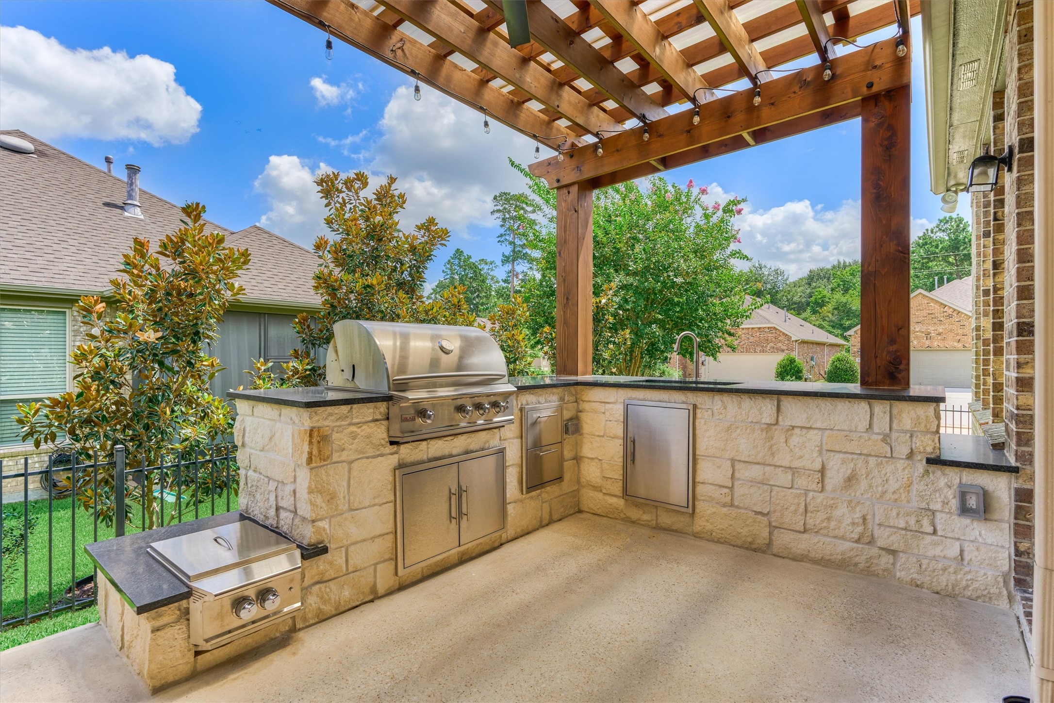 108 Wild Wick Way Spring, TX 77382 - Photo 39 of 44 The Summer Kitchen Features A Sink, Large Grill, Power Burner (for those crawfish boils), And Granite Counters That Look Just Like Soap Stone (just more durable)!