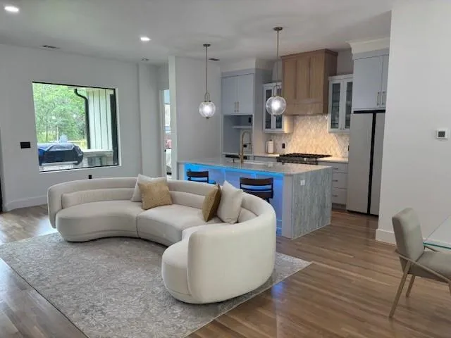 a living room with kitchen island furniture and a window