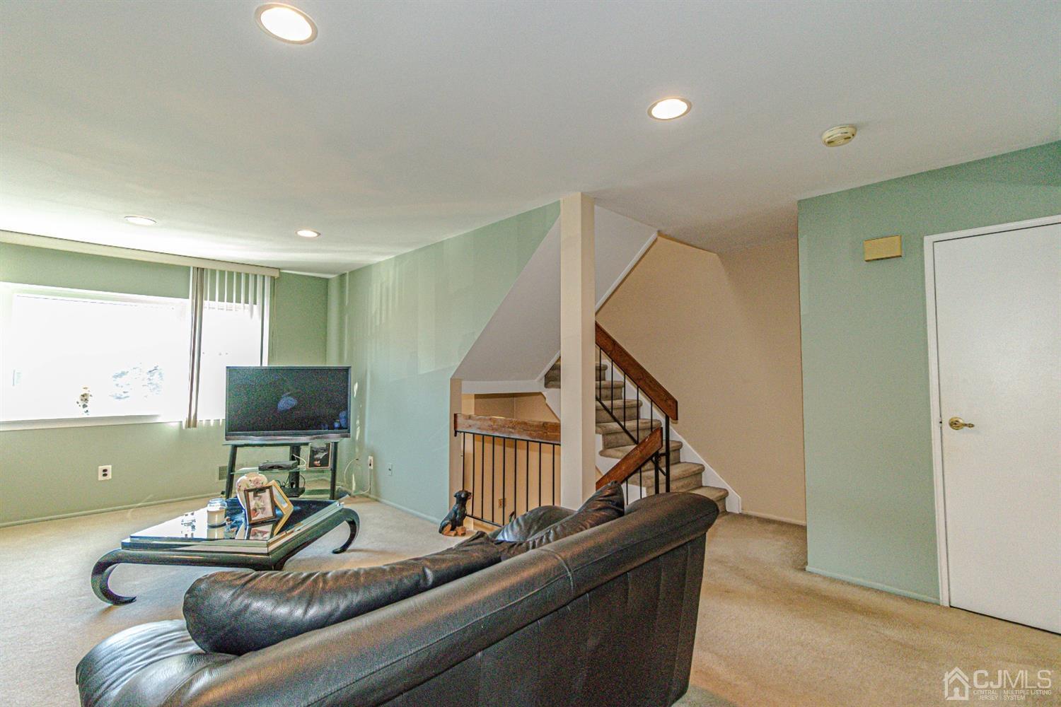 6803 Hana Road Edison, NJ 08817 - Photo 11 of 25 a living room with furniture and a flat screen tv