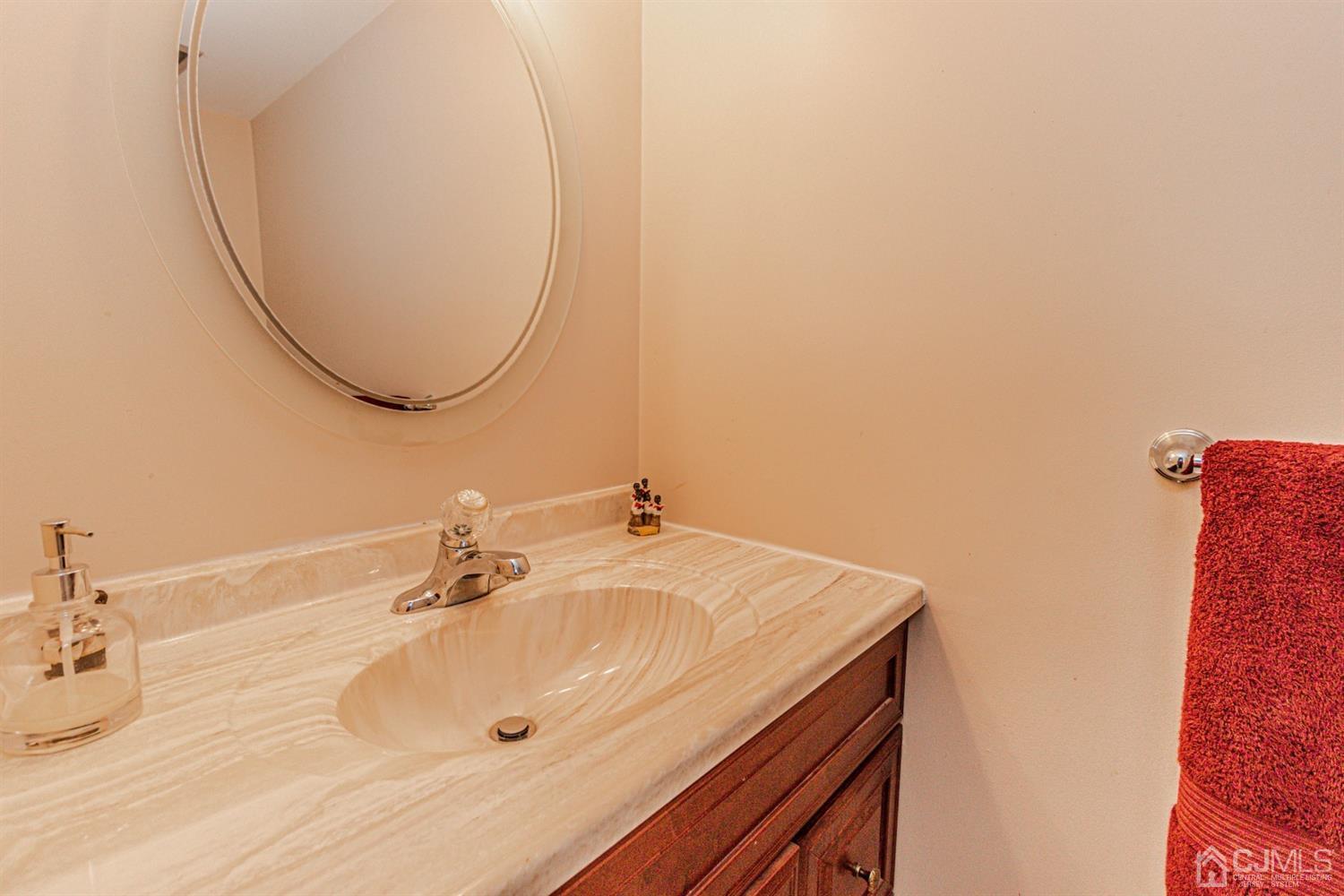 6803 Hana Road Edison, NJ 08817 - Photo 12 of 25 a bathroom with a sink and a mirror