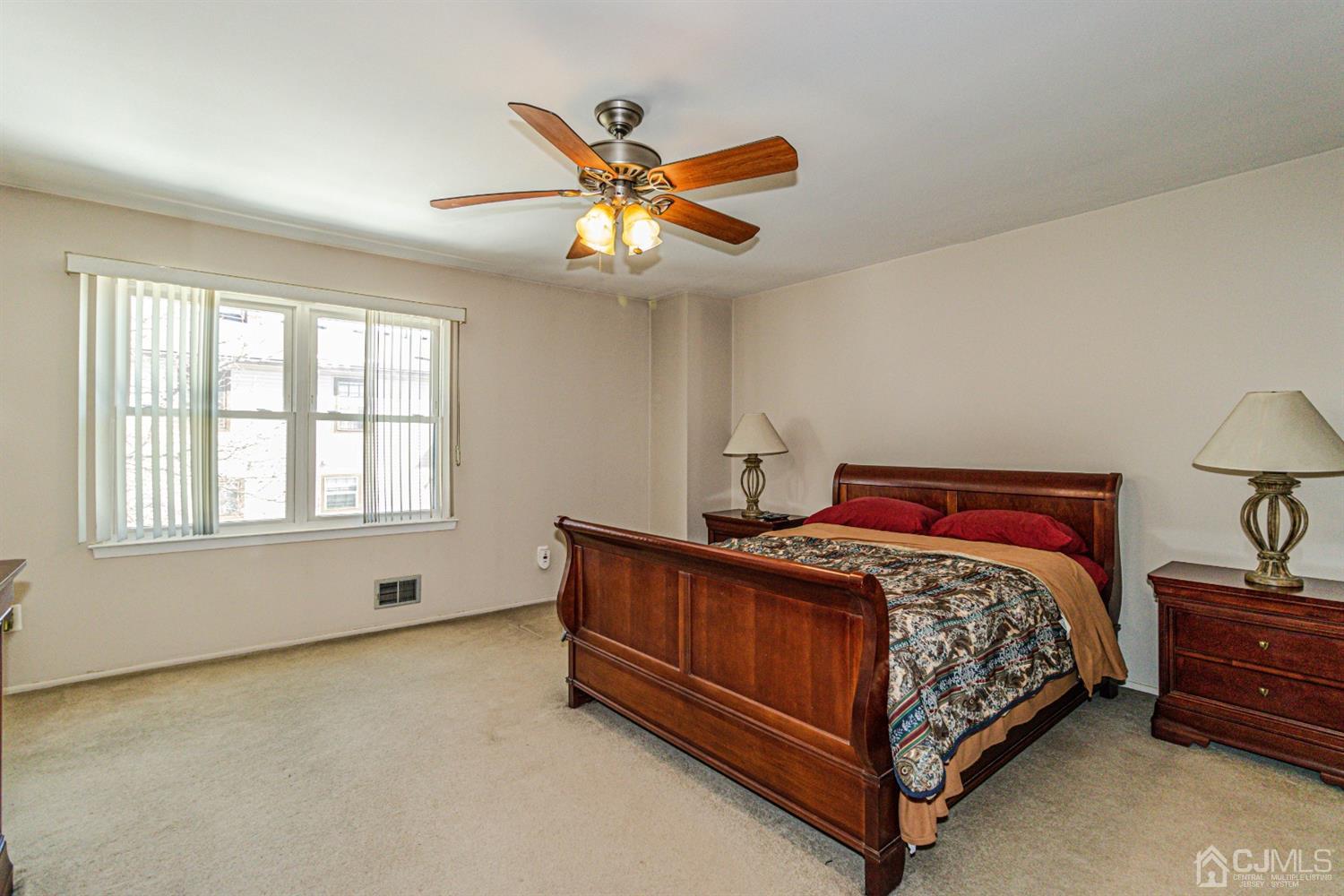 6803 Hana Road Edison, NJ 08817 - Photo 14 of 25 a bed sitting in a bedroom next to a window