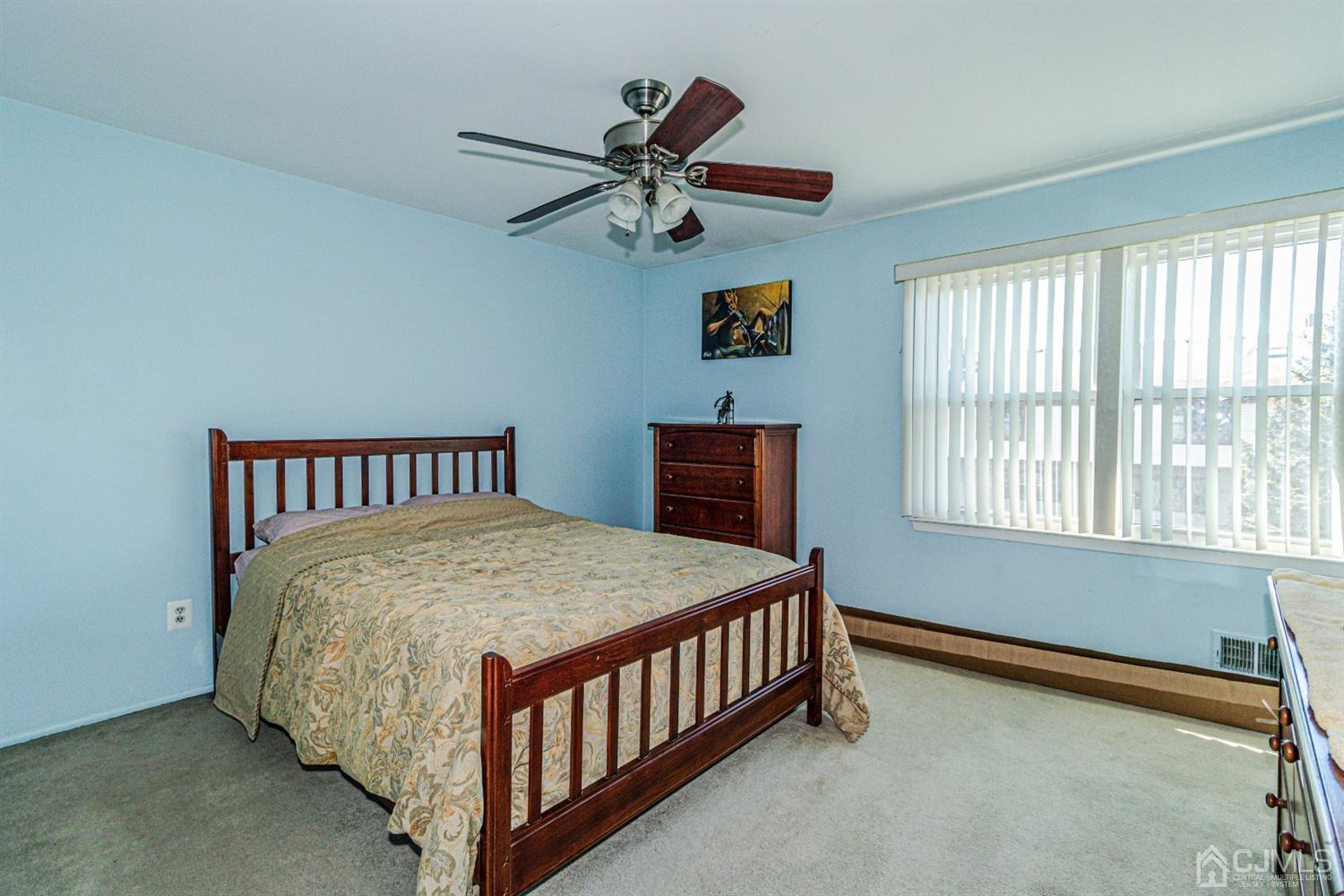 6803 Hana Road Edison, NJ 08817 - Photo 16 of 25 a bedroom with a bed and window