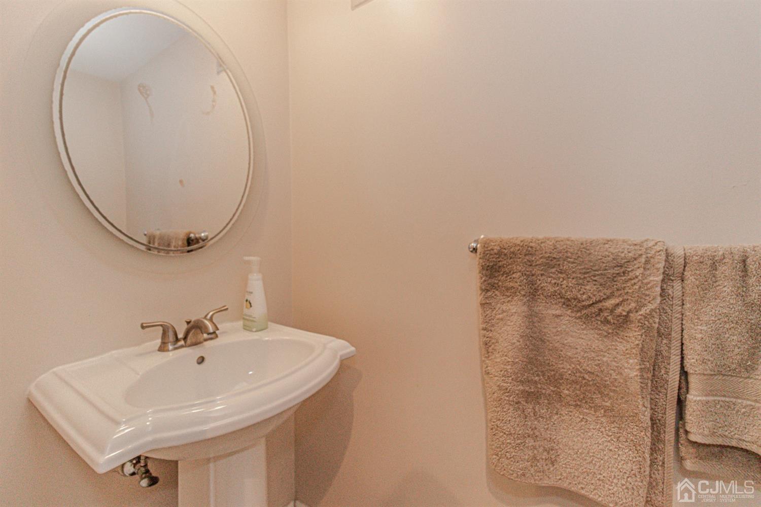 6803 Hana Road Edison, NJ 08817 - Photo 19 of 25 a bathroom with a sink a mirror and shower