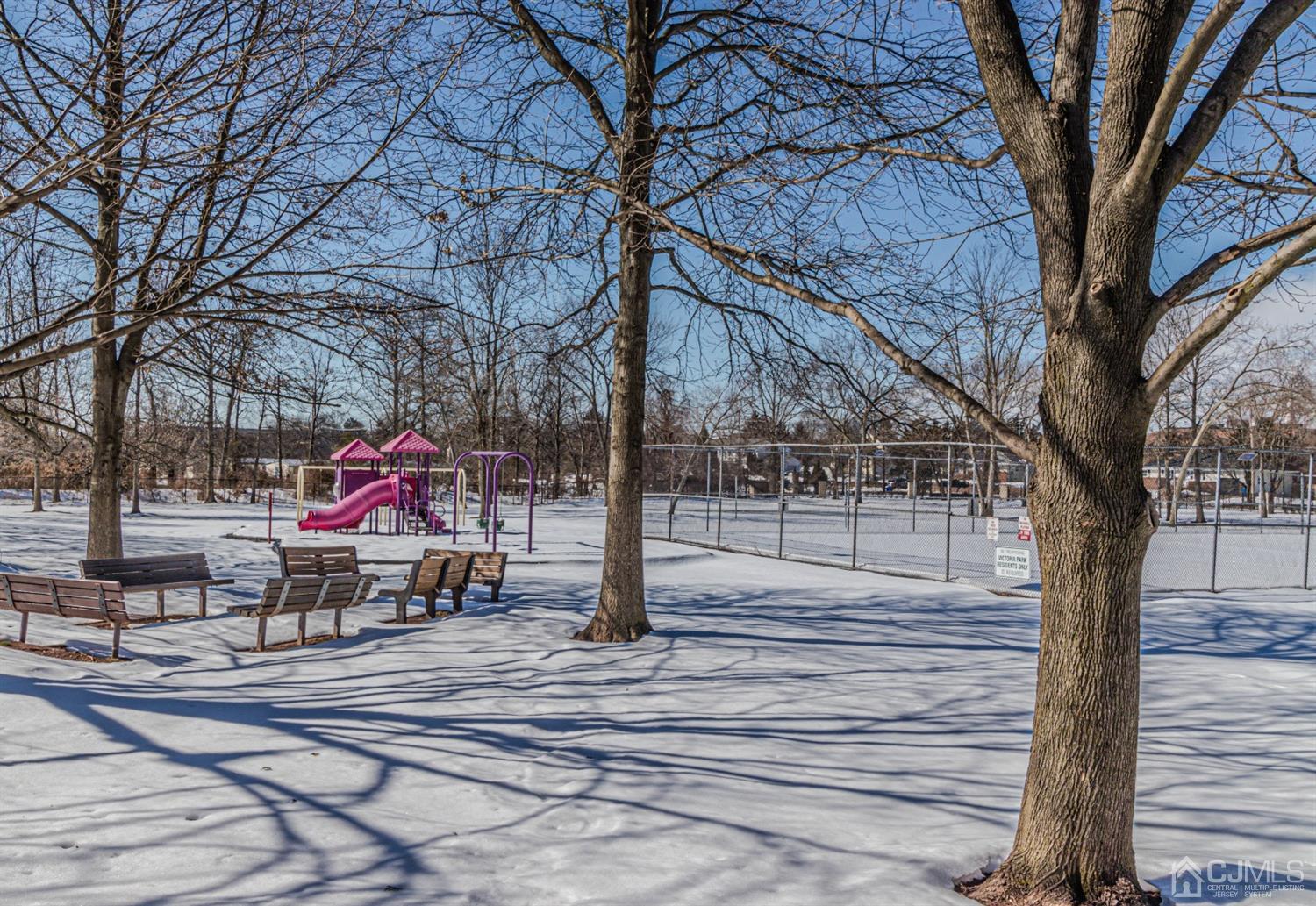 6803 Hana Road Edison, NJ 08817 - Photo 23 of 25 a park view with a bench and trees