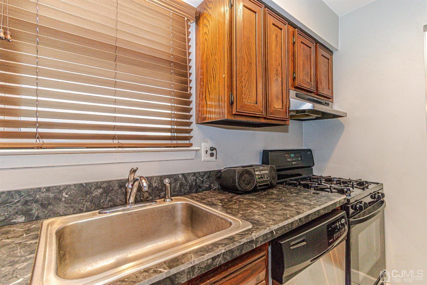 6803 Hana Road Edison, NJ 08817 - Photo 5 of 25 a kitchen that has a sink and a stove
